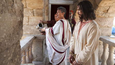 Pilate, washing his hands before the multitude as Jesus looks on