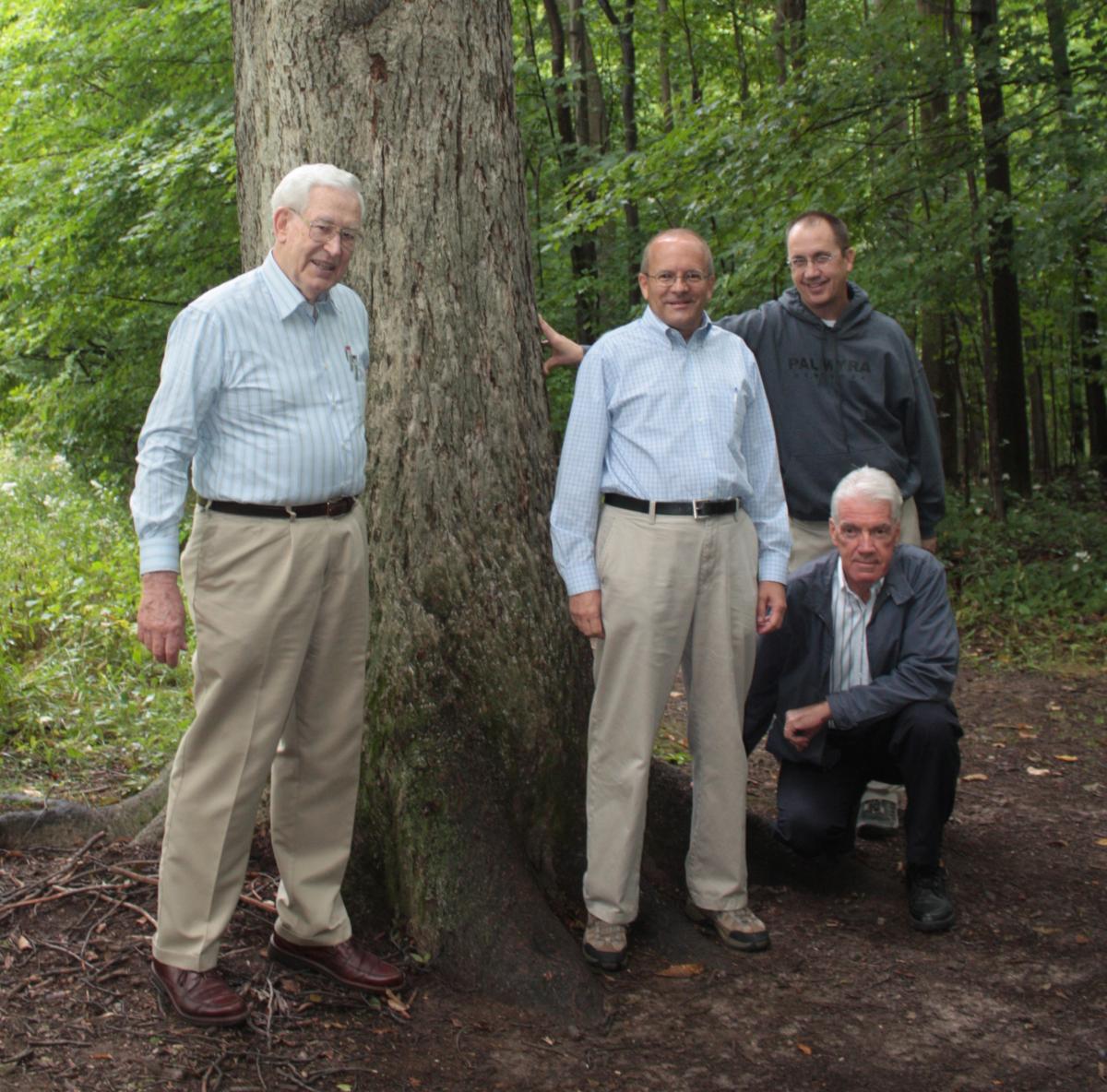 "Larry Porter, Kent Jackson, Richard Holzapfel, and Don Enders standing next to witness tree"