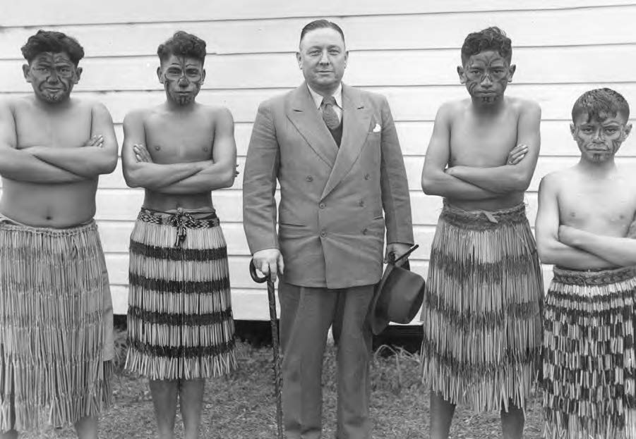 Fig. 4. Matthew Cowley with four Maori boys dressed for a cultural performance Courtesy of Church Archives