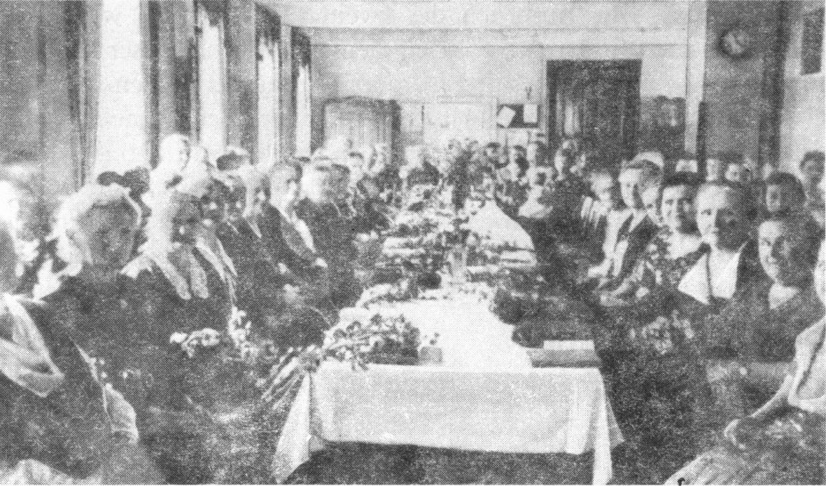 People gathered around long dinning table