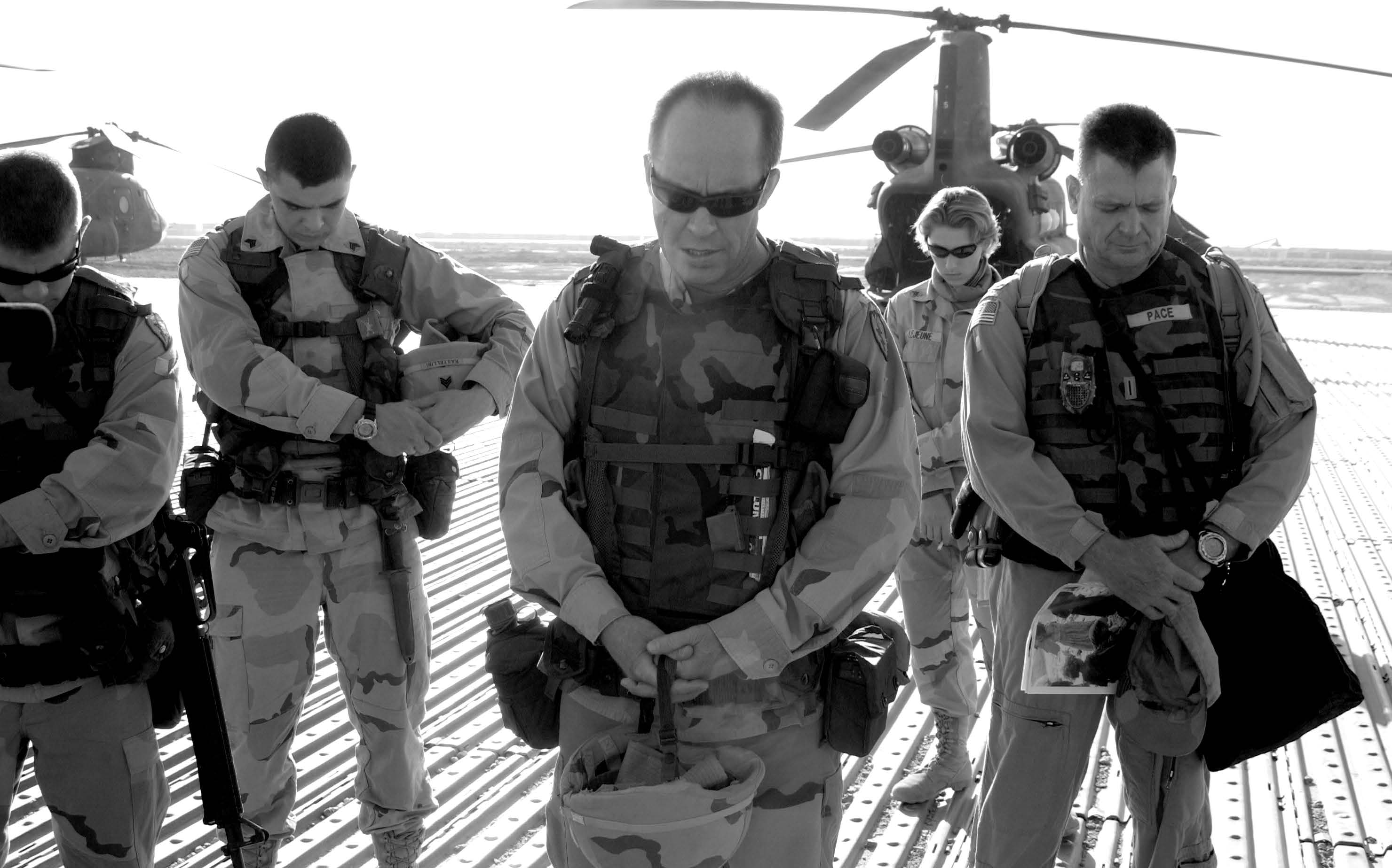 Chaplain Mark Allison (center) is shown leading a group in prayer before a mission. Courtesy of Mark Allison.
