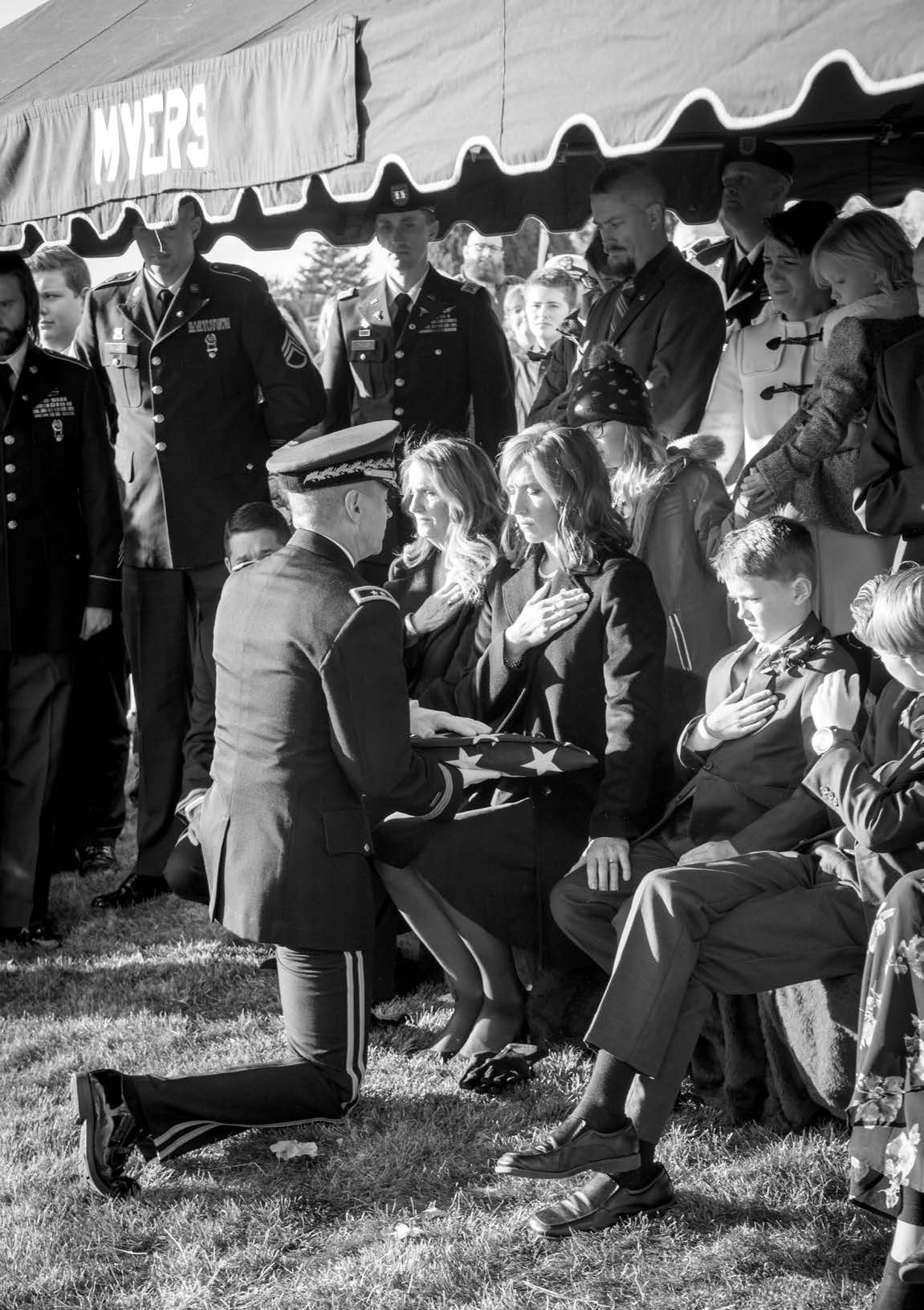 Jennie Taylor, widow of Major Brent Taylor, receives the U.S. flag that draped her husband’s casket from Major General Jefferson S. Burton, the Adjutant General of the Utah National Guard, in November 2018. Courtesy of Westbroek Studios.