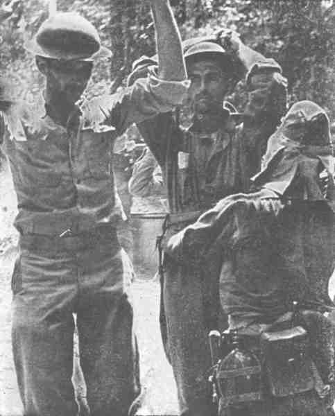 photo of american soldiers being searched by japanese soliders after surrendering