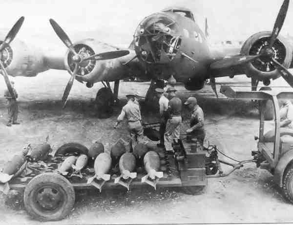 photo of soldiers loading a b-17d plane with bombs