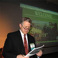 An attendee scanning the symposium program