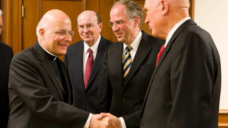 A Catholic leader and Latter-day Saint leaders shaking hands