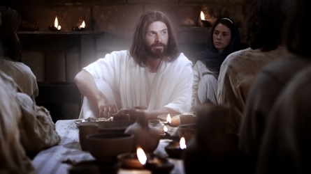 Christ behind a lighted table with his disciples at the last supper
