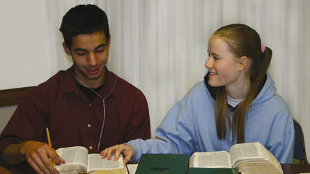 A boy and a girl studying the gospel together