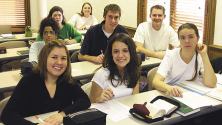 A classroom of students smiling toward the front