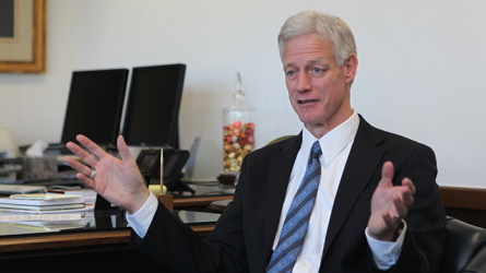 President Kevin J Worthen behind his desk gesturing with his hands