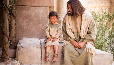 Jesus sitting on a low wall, talking with a young child