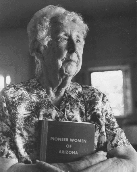 Roberta Flake Clayton holding Pioneer Women of Arizona.