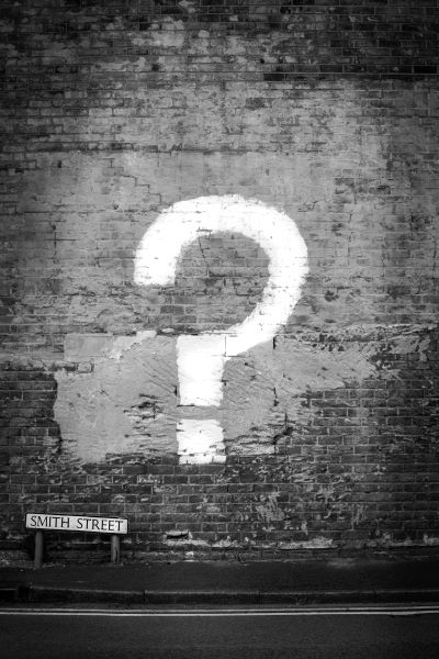 image of a graffiti question mark on a brick wall