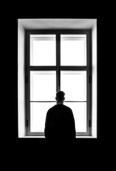 photo of a man in front of a window