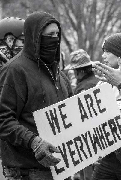 Man holding a 'We are everywhere' sign