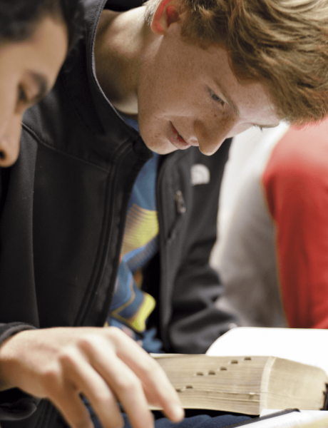 Photo of a young man studying the scriptures