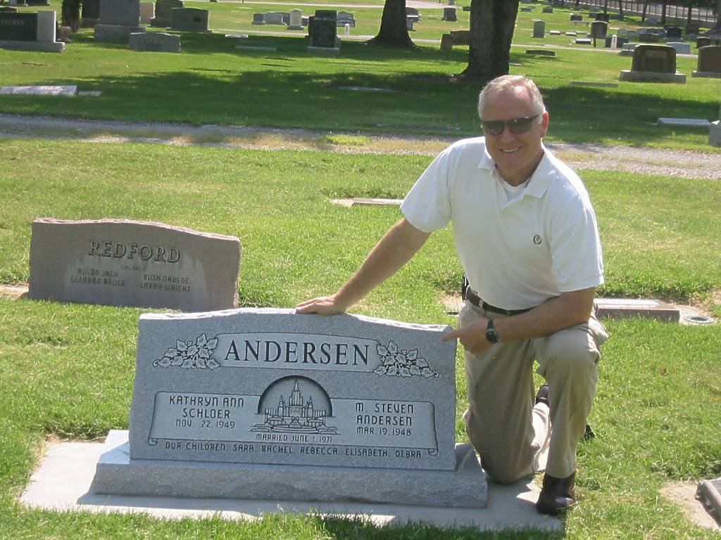 Man next to gravestone