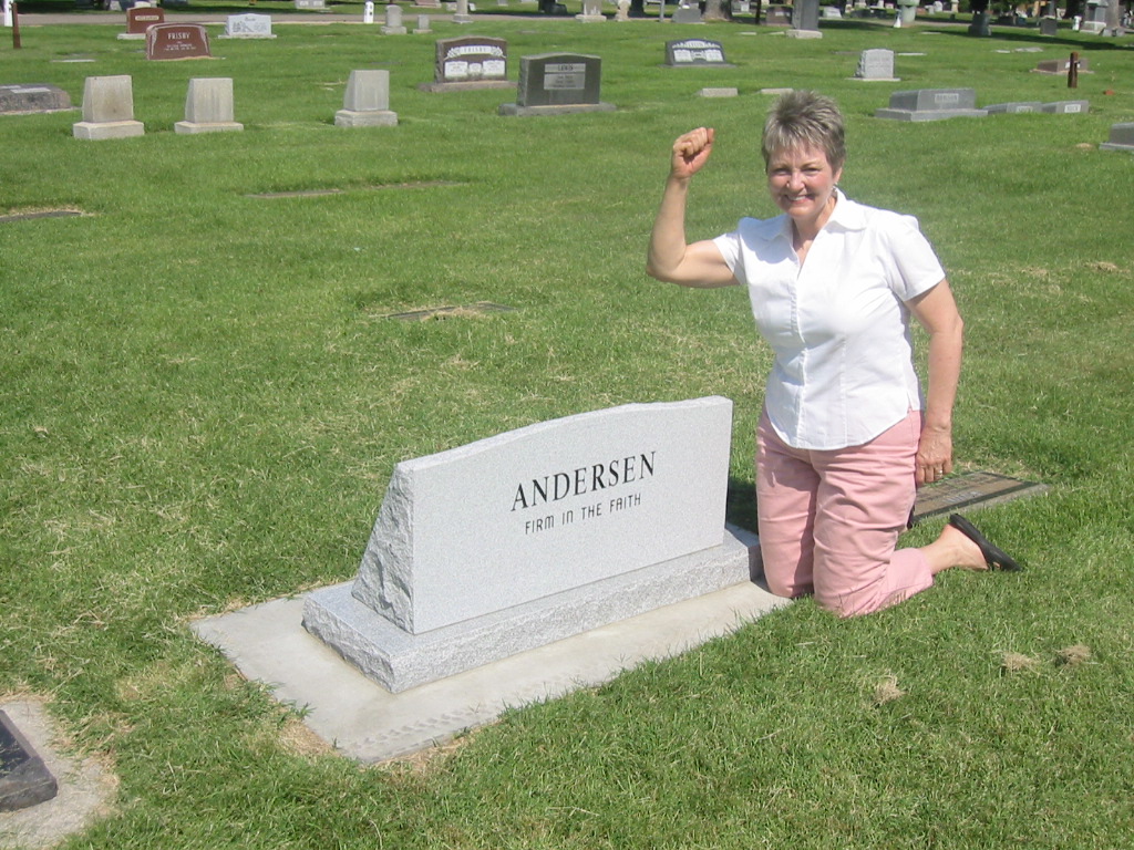 Woman next to gravestone