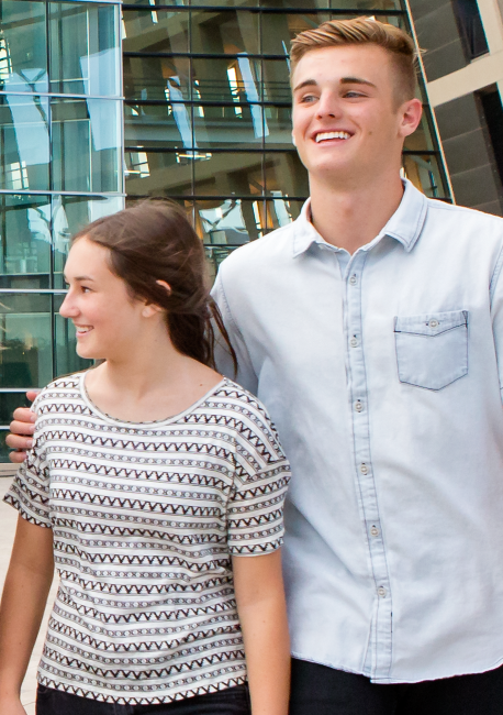 Two youth walking and smiling together