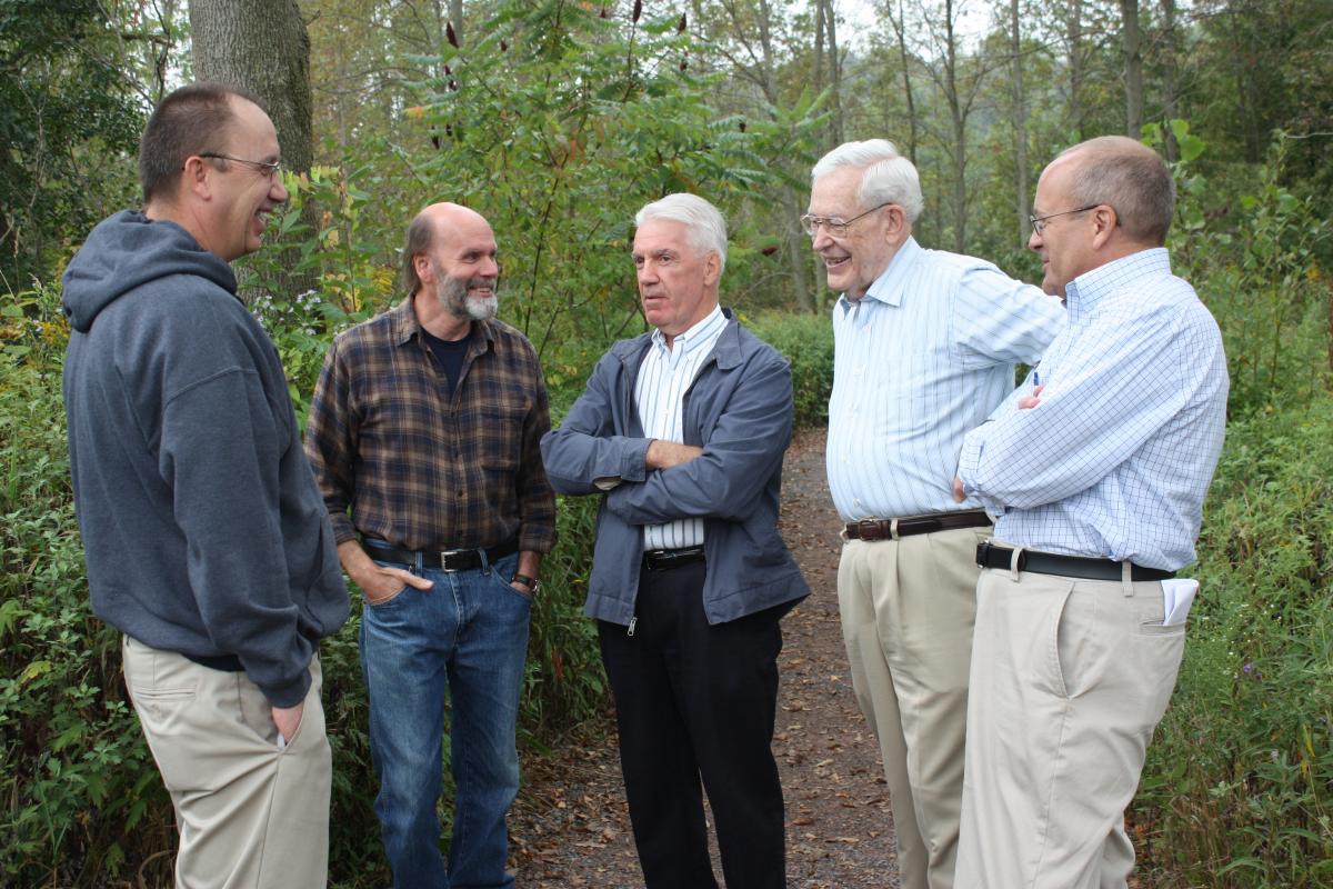 "Richard Neitzel Holzapfel, Robert Parrot, Donald L. Enders, Larry C. Porter, and Kent P. Jackson standing in the Sacred Grove"