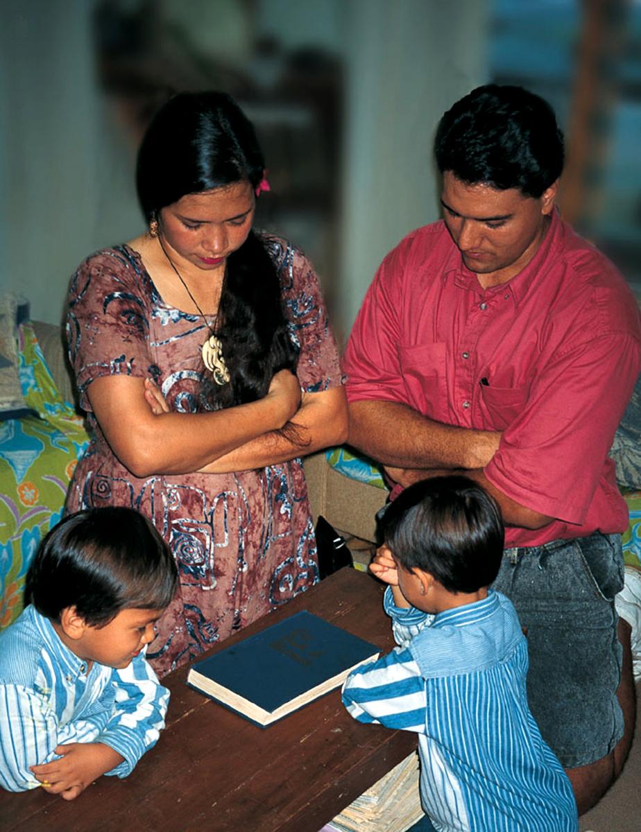 A family kneeling together in prayer