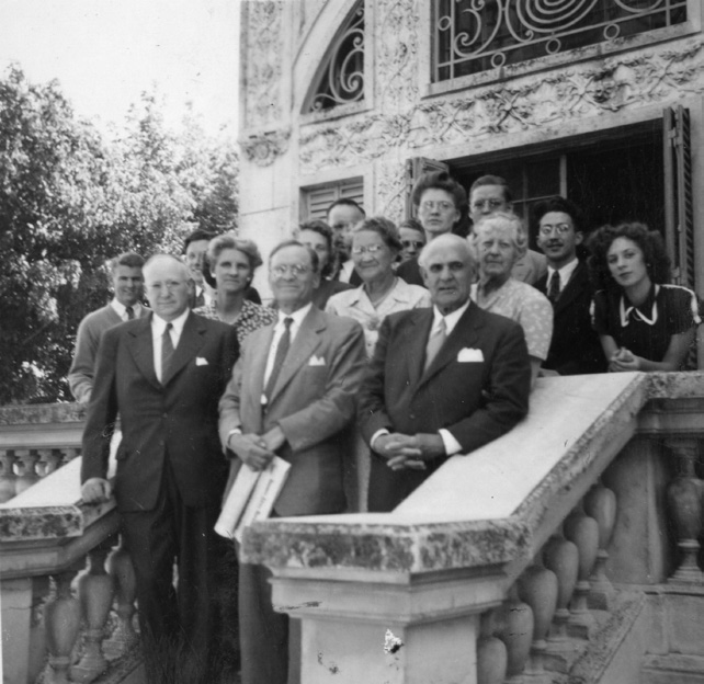 Meeting of mission presidents and missionaries, with Frederick S. Williams, W. Ernest Young, and Stephen L Richards in the front row and their wives standing immediately behind them. Courtesy of CHL.