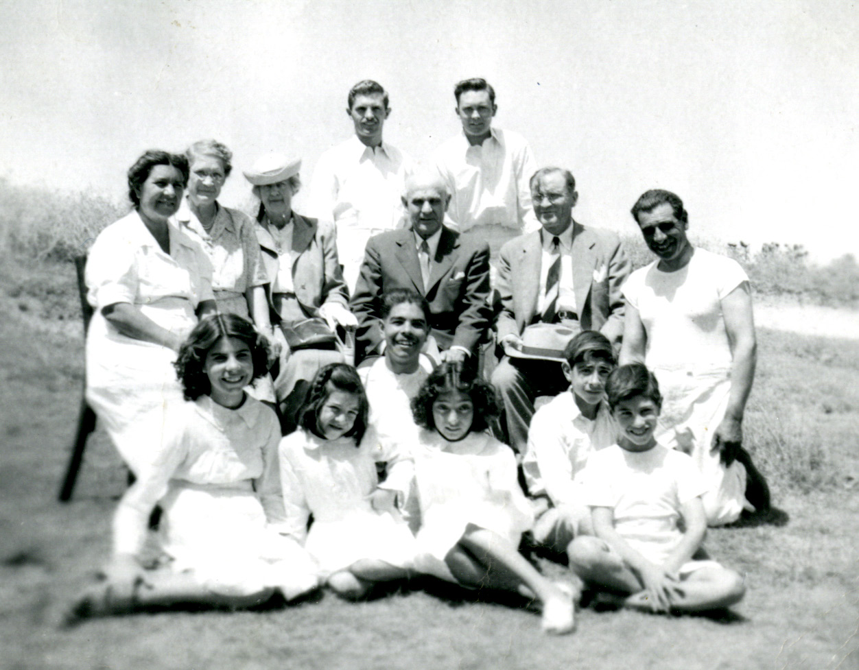 The Youngs and the Richardses sit with the Maldonado family and young girl who were baptized. Elders Carroll and Marble are standing. Courtesy of CHL.