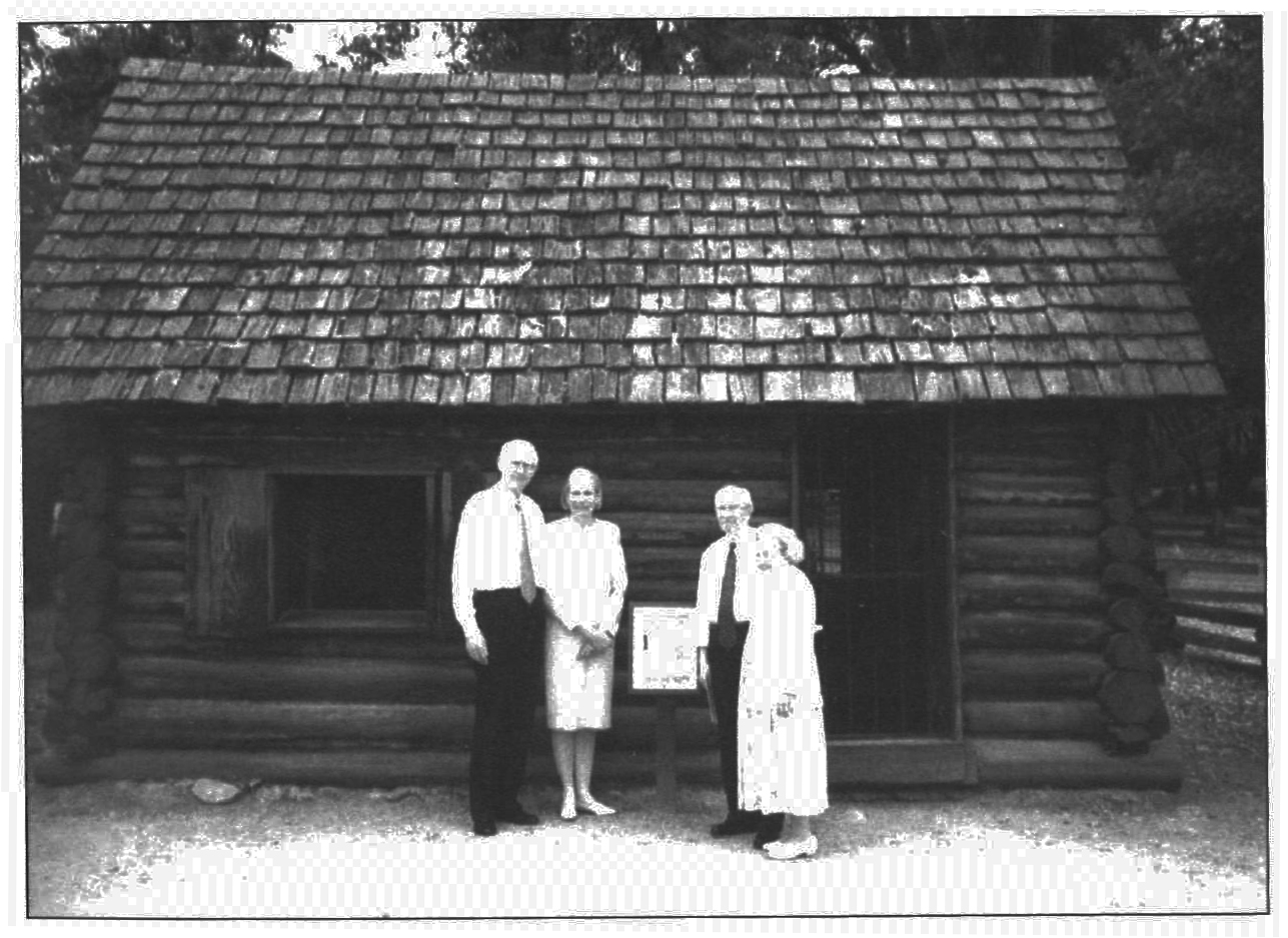 Church president Gordon B. Hinckley and area president Loren C. Dunn with their wives in front of Mormon Battalion cabin at Coloma