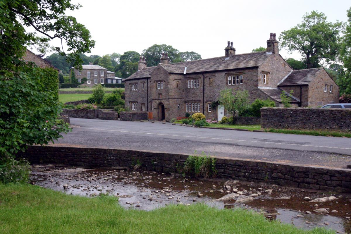 small river and road with buildings in the background