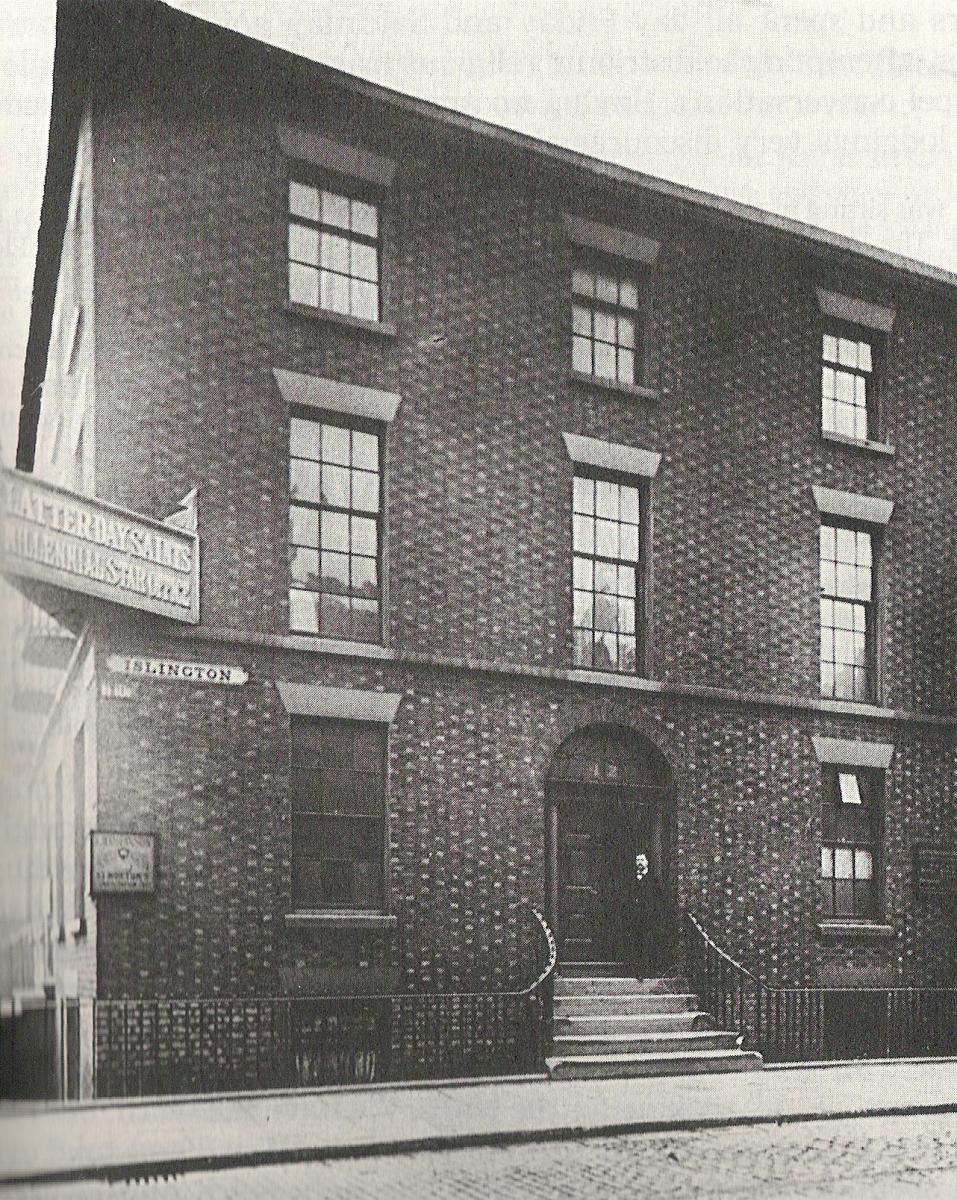 black and white photo of three story building with windows