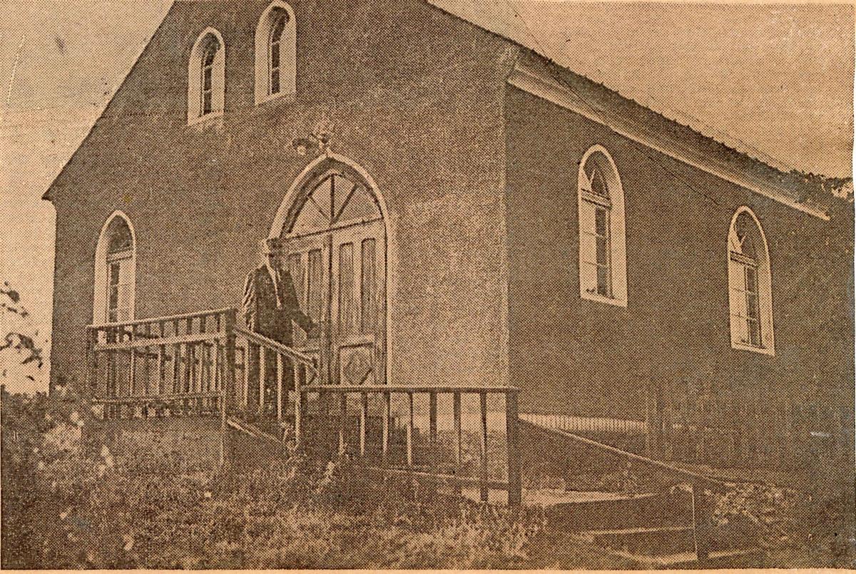 Branch church building with man standing in front of door
