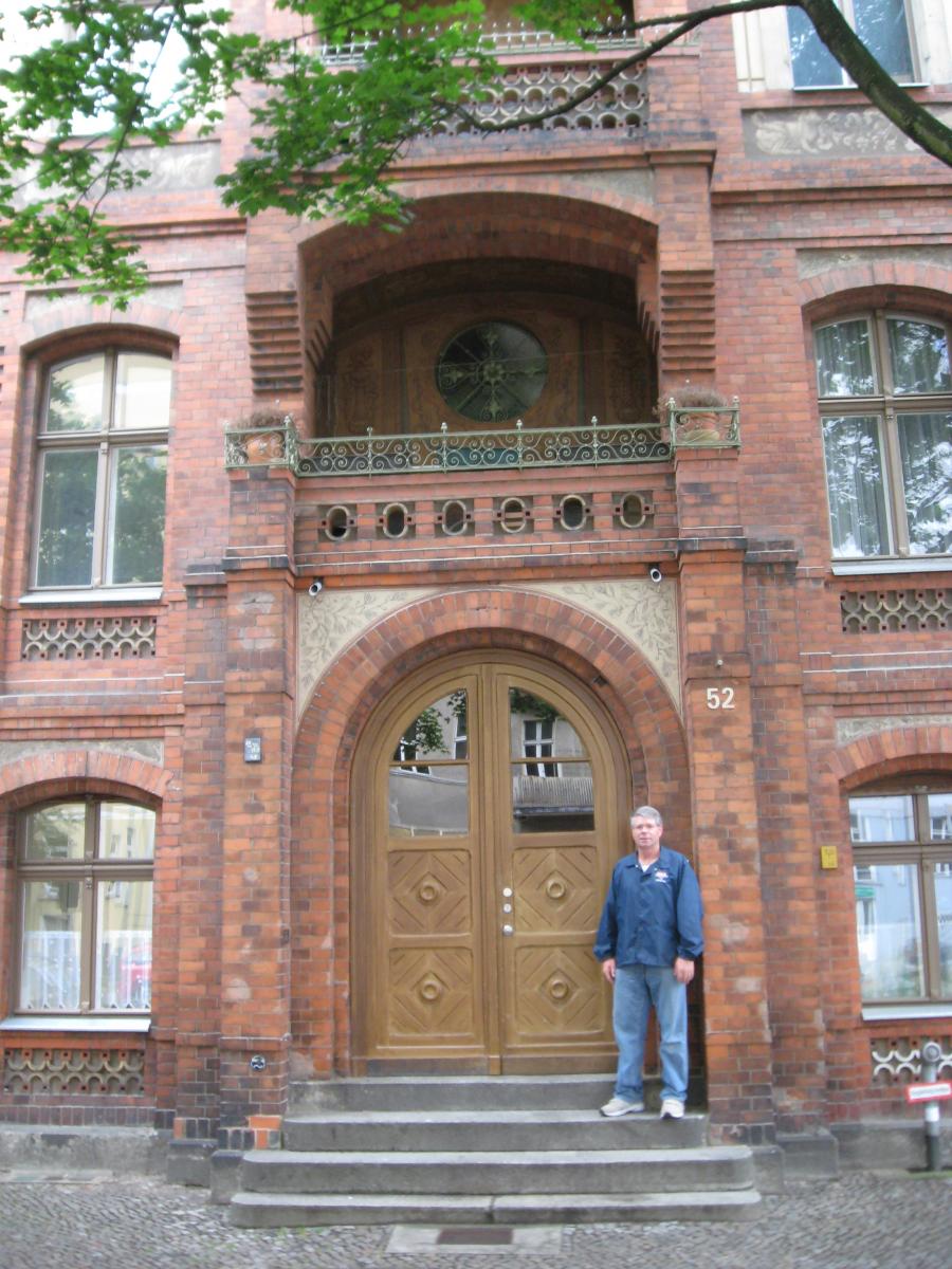 Roger Minert in front of apartment building