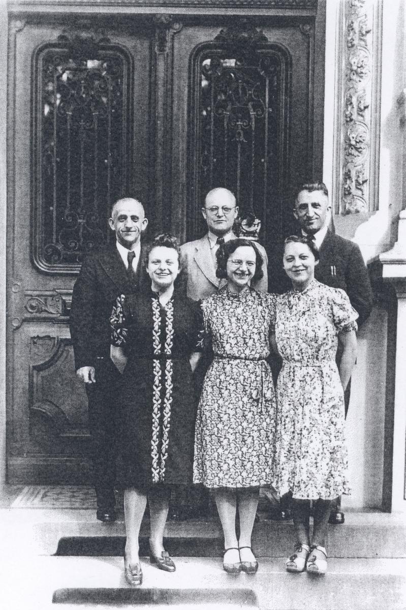 Mission leaders and office staff in front of building