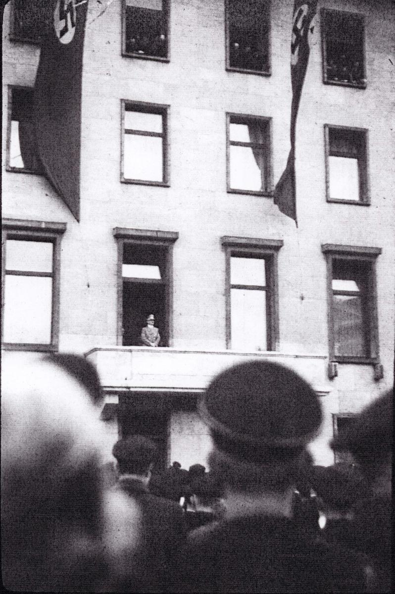 Adolf Hitler greets a crowd of well-wishers from the balcony