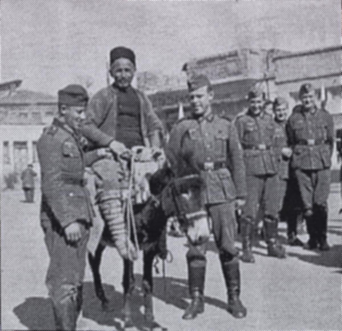 Wilhelm Werner on donkey with soldiers around