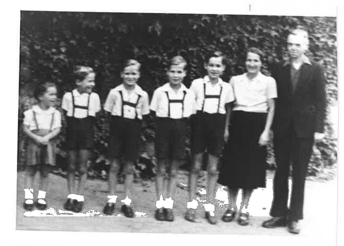 man and women standing with children