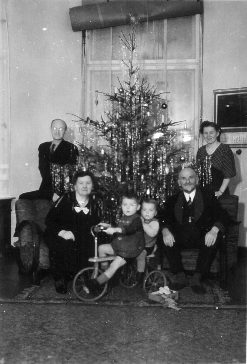 Family around Christmas tree