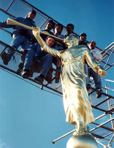 Emotion filled the large crowd as the figure of Moroni was unwrapped and shone golden in the sun. Crew members, left to right: Adam Hatch, Cesar OntiverÓs, Bernardo Gallegos, Oscar González, Eduardo Paredes, and Marco Antonio Avalos, and Chad Call (seated). Courtesy of David Wills.
