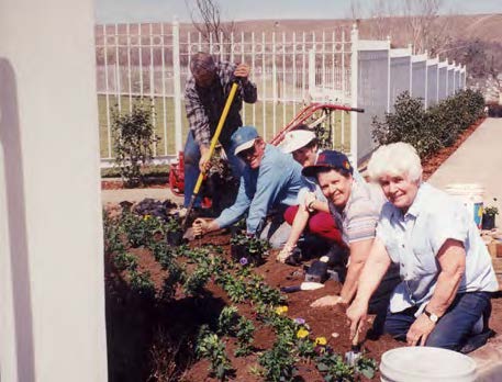 Above, front to back: Joan Thomas, DeAnne Whetten, Christine and Kelly Romney, Maurice Bowman planting flowers. Below: Obrera Ward bishop Pedro Vazquez and other volunteers.