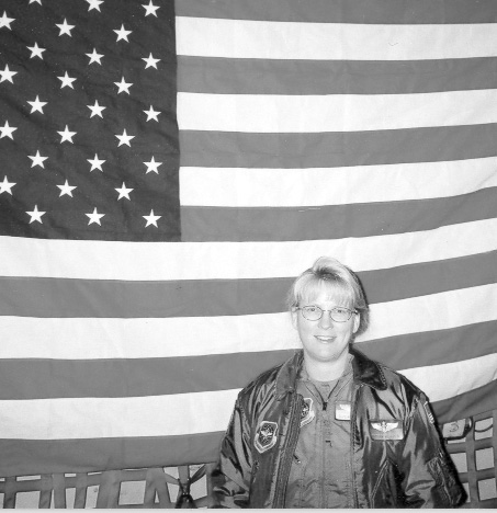 Susan Herron with a flag that her unit kept in their plane