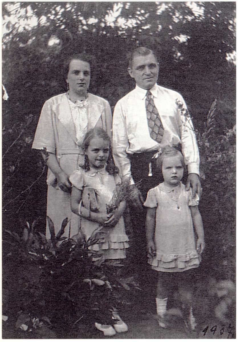 mother father and two daughters outside