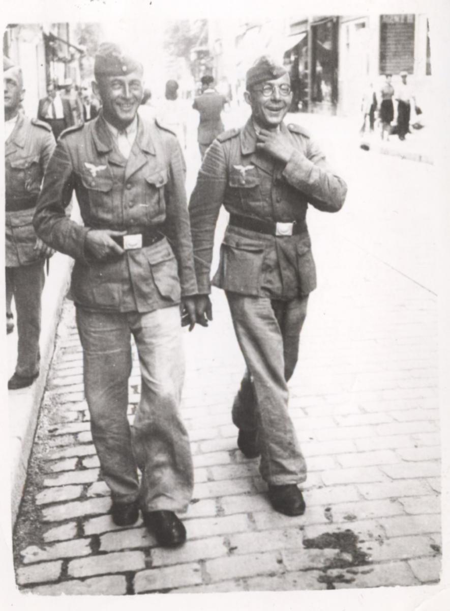 two soldiers smiling and walking on street