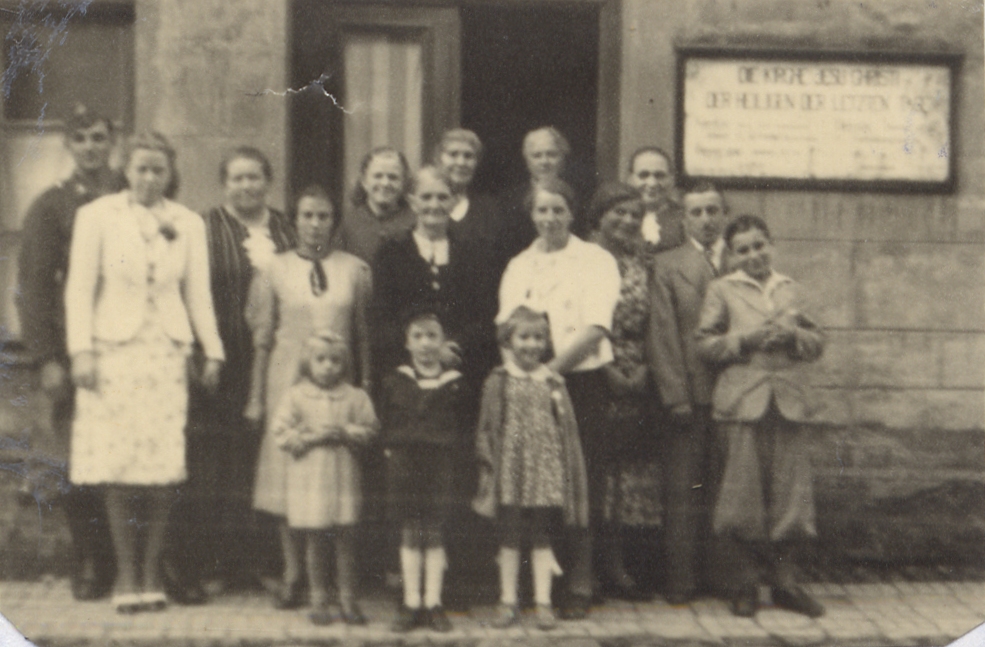Insterburg Saints posing for a photo outside building