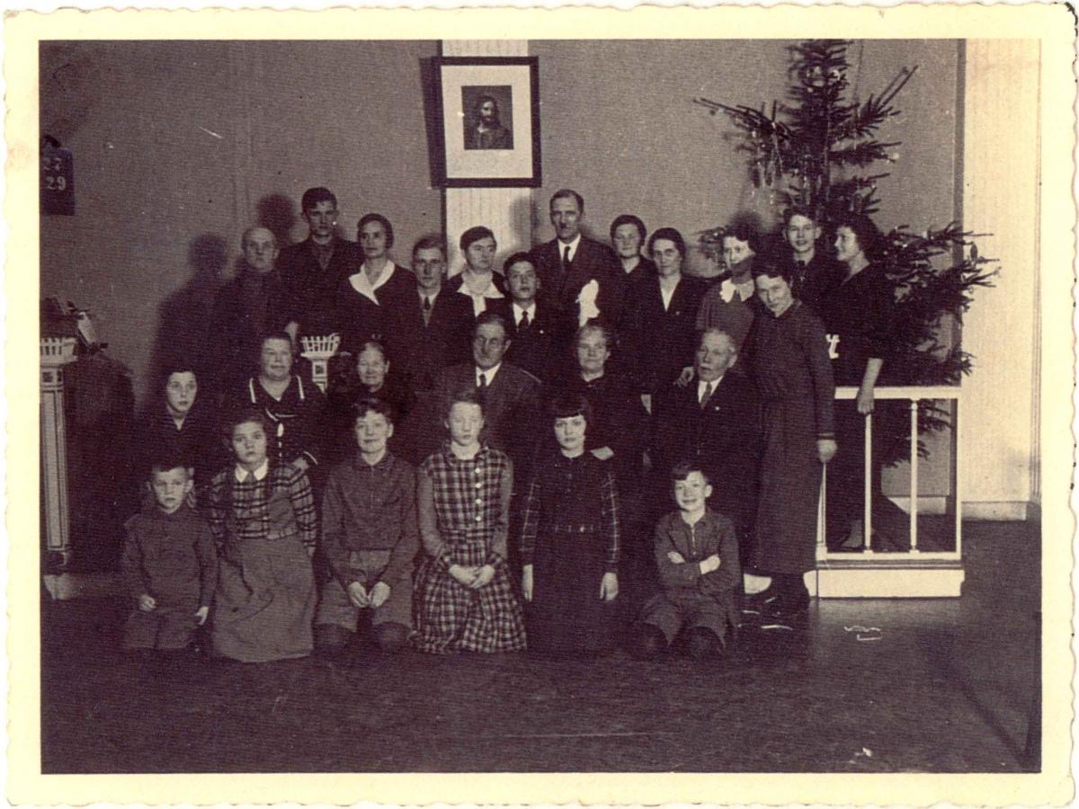 Members of the Neubrandenburg Branch gathered below painting of Jesus