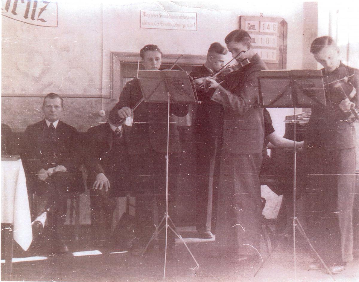 Four young men and a young lady playing music