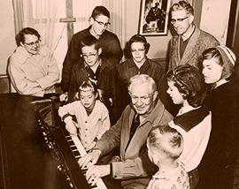 A Family gathered around the piano