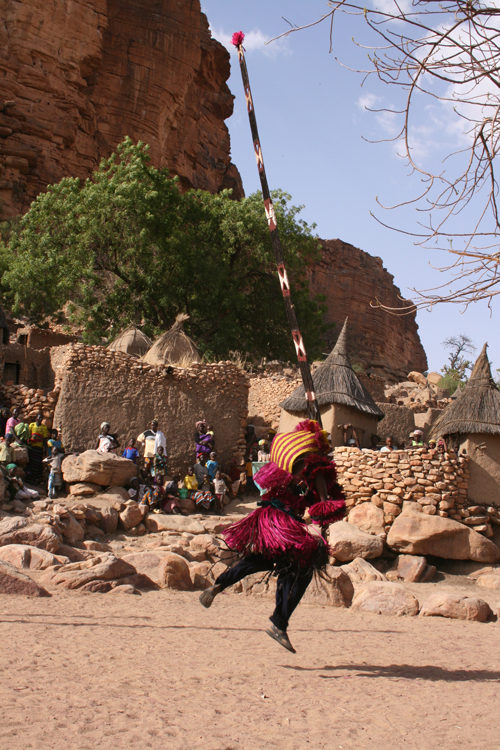 A man in cultural dress performing some type of ritual