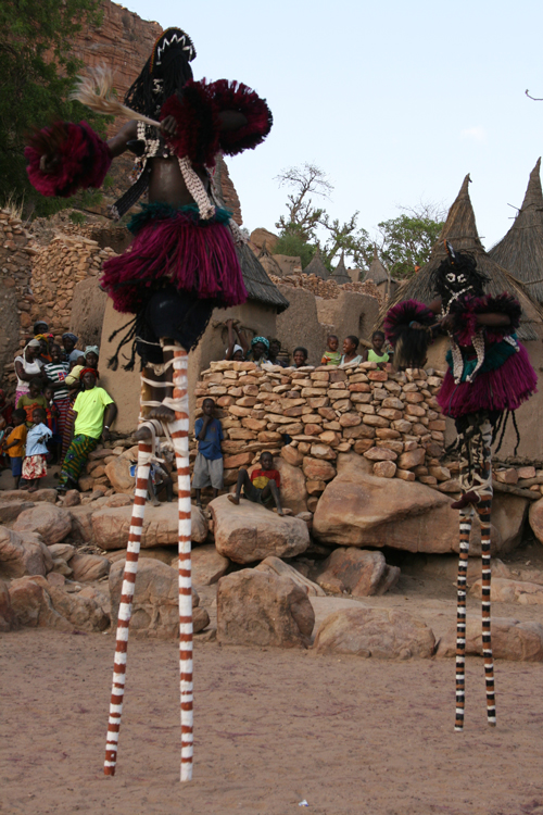 Two Dogon stilt masks performing in an imagistic, maximal ritual.