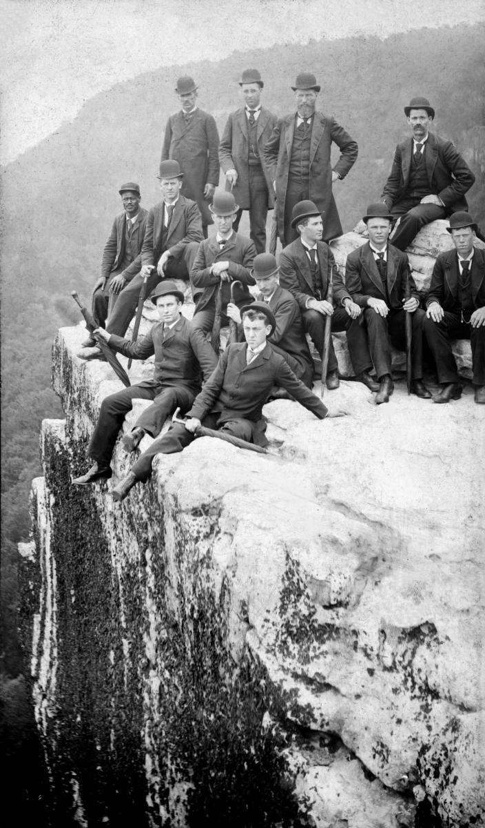 Elders from the Southern States Mission sitting on a cliff