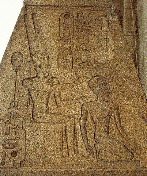 Scene on red granite obelisk